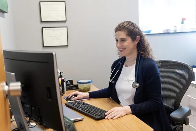 a medical woman at a computer