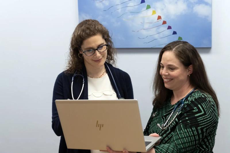 two women looking at a laptop