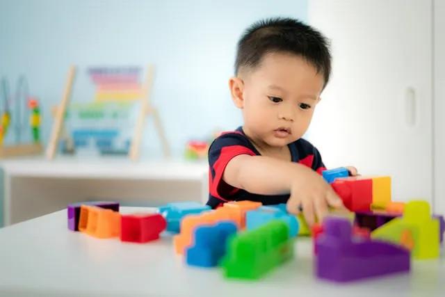 a boy playing with blocks