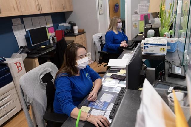 Front office staff sits at computers